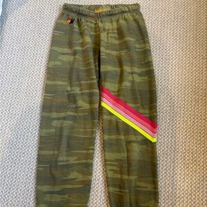 Aviator Nation camo sweatpantseatpants with rainbow stripe.